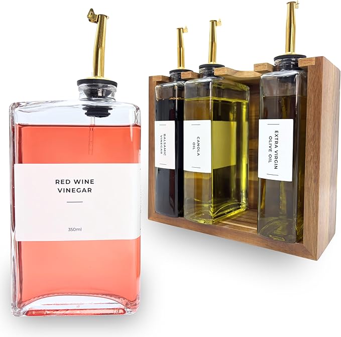 The Oil Library | Glass Oil & Vinegar Bottles with 100% Acacia Wood Stand | 4 Containers, 5 Gold Nozzles & 35 Stain-Resistant Labels | Countertop Display Set